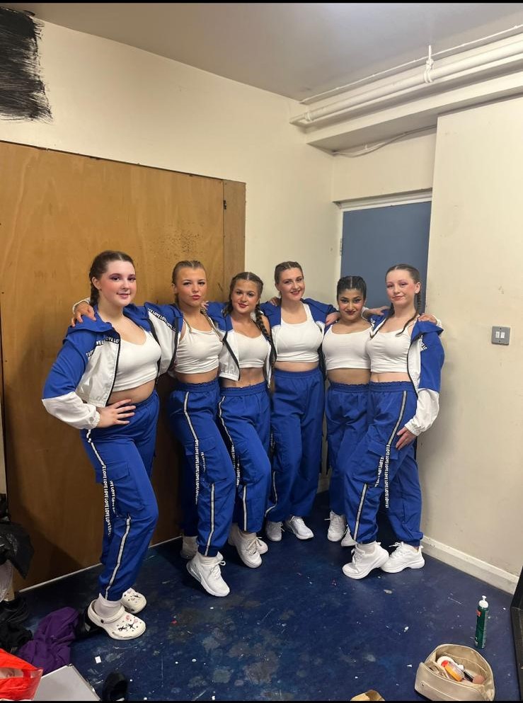 Jazz performance with matching costumes at dance show